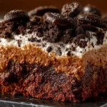 Oreo dirt cake in 9x13 white dish with crushed Oreo crumb layers, creamy vanilla pudding cream cheese Cool Whip filling, Oreo crumb topping, and colorful gummy worms on gray surface ready in 15 minutes
