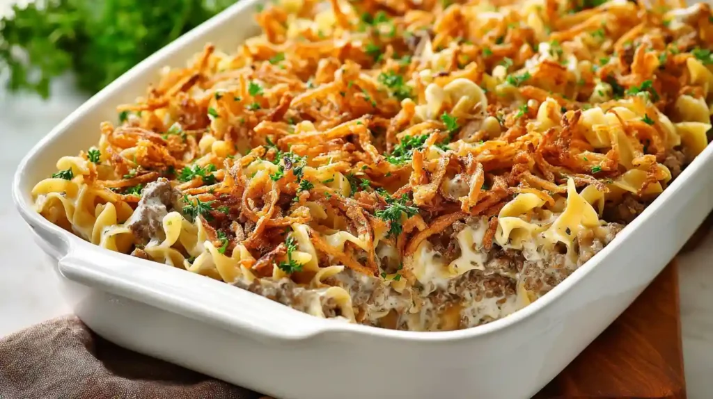 French onion beef casserole one-pan comfort dinner ready 1 hour with 2 tablespoons unsalted butter large skillet medium-high melted, 1 large yellow onion thinly sliced sautéed stirring occasionally 25-30 minutes very tender caramel golden color, 2 pounds ground beef 1 packet onion soup mix half teaspoon kosher salt quarter teaspoon black pepper added cooked no longer pink 5-7 minutes excess grease removed, 3 cups beef broth 2 cans 10.5-ounce condensed French onion soup poured stirred, 12 ounces egg noodles pressed under liquid completely submerged brought boil covered reduced medium-low simmered 10-12 minutes tender, Gruyere or Swiss cheese scattered broiled 2-3 minutes golden bubbly served immediately