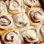 The best cinnamon rolls ever with pillowy soft bread flour dough, dark brown sugar cinnamon filling, softened butter swirl, and luscious tangy cream cheese frosting baked at 350°F in 9x13 pan until golden and gooey