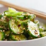 Asian Cucumber Salad with thinly smashed cucumbers rice vinegar sesame oil soy sauce garlic chili oil toasted sesame seeds and fresh cilantro