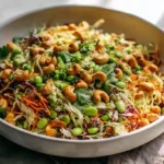 Cashew Crunch Salad with Sesame Dressing loaded with colorful shredded cabbage carrots bell peppers edamame chow mein noodles roasted cashews and cilantro in creamy sesame dressing