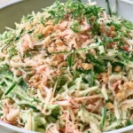 Kani Salad Recipe with shredded imitation crab cucumber carrot lettuce mango and creamy Japanese mayo dressing topped with sesame seeds
