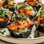Easy Baked Salmon Sushi Cups with seasoned sushi rice nori salmon avocado sesame seeds and spicy mayo baked in a muffin tin