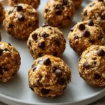 No-Bake Peanut Butter Energy Bites with round oat peanut butter snack balls studded with chocolate chips in a white bowl